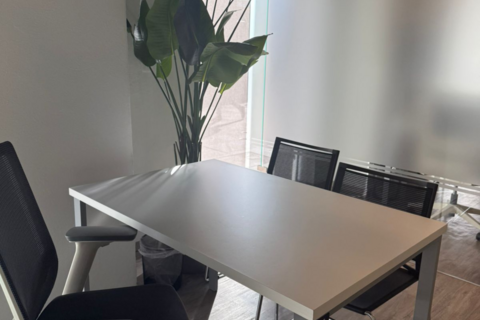 a desk with a laptop computer sitting on top of a table