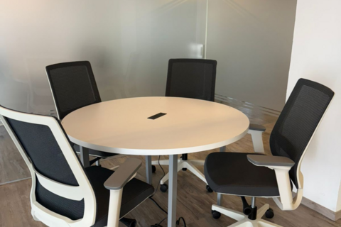 an office with a desk and chair in a room