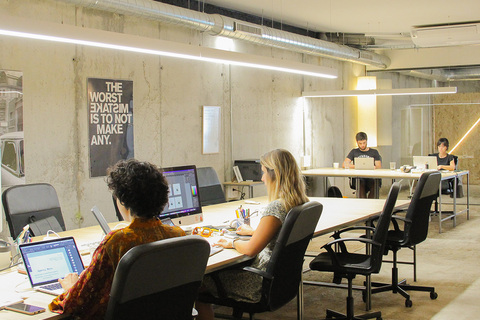 a group of people sitting at a desk