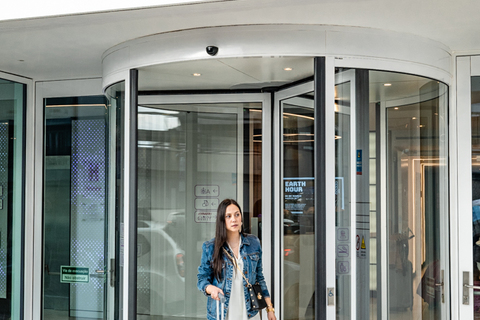 a woman with luggage in front of a building