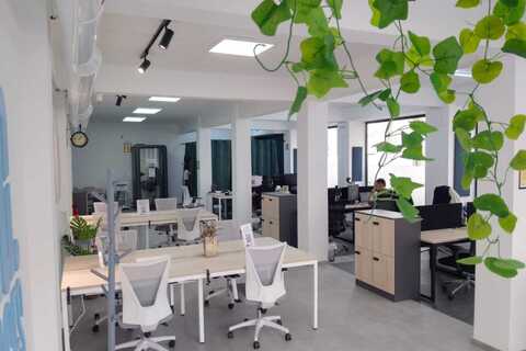 a room with white chairs and tables