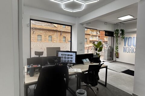 a room with a desk and computer