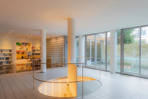 a white room with a circular staircase