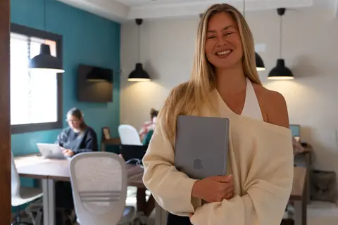 a woman holding a laptop